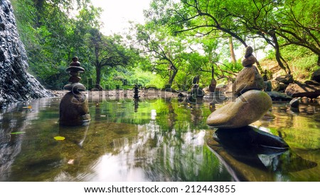 Zen garden. Meditate spiritual landscape of green forest with calm pond water and stone balance rocks
