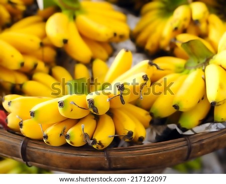 Shallow depth of field photography of ripe yellow bananas on local street market in Asia