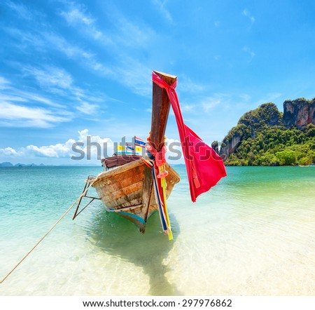 Tourism in Asia. Tropical island and tourist boat on exotic sandy beach in Thailand. Travel background