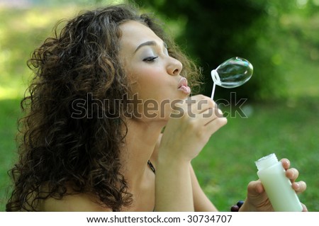 Young woman portrait making soap bubbles