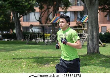 Young man at a local park jogging near home