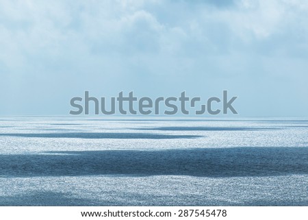 Beautiful horizon over the sea with highlights and shadows reflected over water