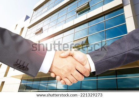Business deal with business building backgraund