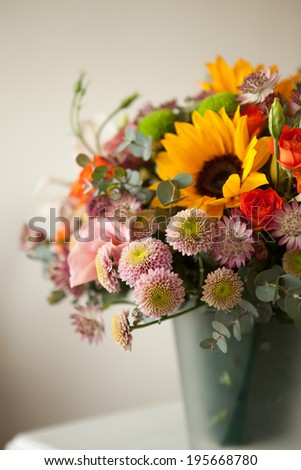 floral bouquet with lily, sunflower, chrysanthemum, eustoma (lisianthus) astrantsiya, eucalyptus, shrub rose