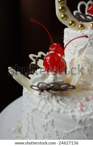 close up wedding cake with cherries and white chocolate.
