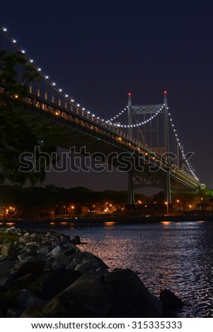 The Triborough bridge lit up at night, as seen from Randall\'s Island.