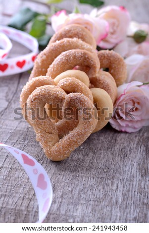 cup of coffee and heart shaped cookies with sugar for valentine on wooden table in vintage style. Selective focus