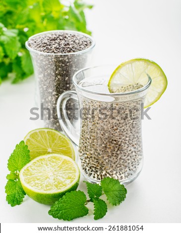 Chia seeds drink with water in transparent glass with lime and lemon balm. selective Focus