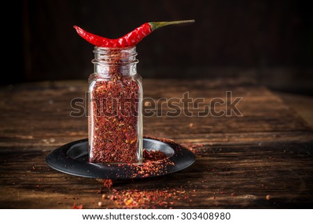 Cayenne pepper and Red peppers on old wooden table. selective Focus