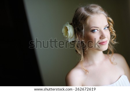 portrait of a beautiful young girl with big blue eyes, blond hair, the bride in her wedding dress