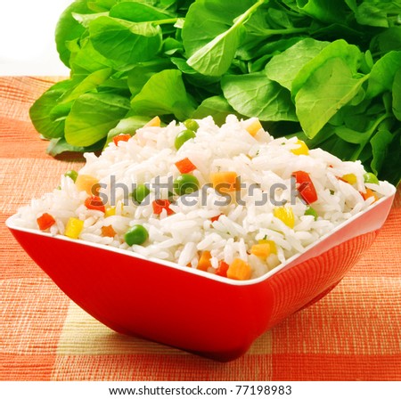 bowl of rice with peas and red peppers
