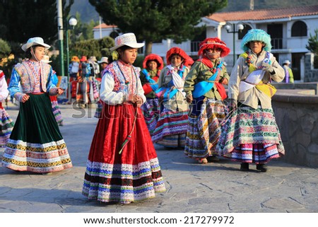 Yanque, Peru - April, 17 2014 :  Peruvian children in traditional dress dancing in Plaza de Armas, Yanque village, near Colca Canyon Peru.