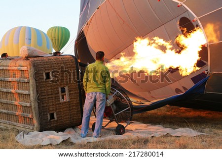 Cappadocia, Turkey - August, 10 2013 :  Ground Crew inflating Hot Air Balloon before launching.