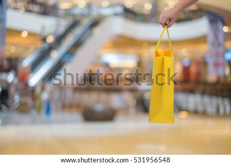 people, sale and consumerism concept - close up of woman with shopping bag