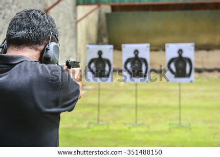the man shooting with gun