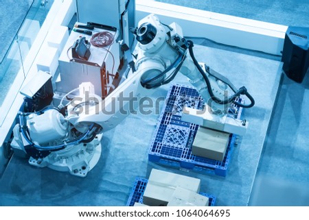 Robotic arm at production line with automatic conveyor belt, industry track.