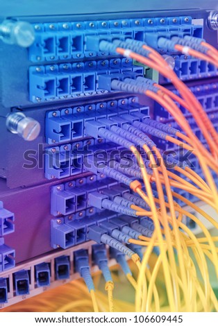 closeup of fiber optical network hub and cables