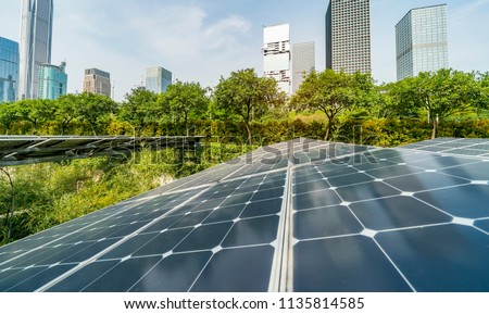 solar panel with skyscrapers of in blue cloud sky,Green city of the future concept