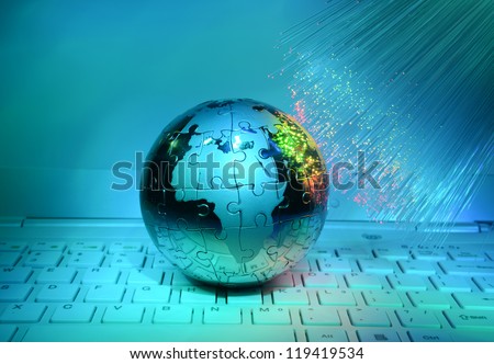technology steel earth on laptop keyboard against fiber optic background