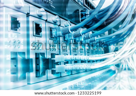 Network cables connected to ethernet ports,Fiber Optic cables connected to optic ports and UTP.
