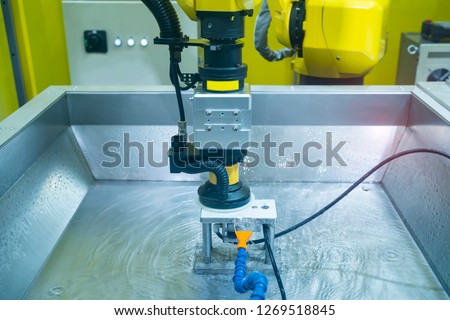 robot arm polishing the mobile phone part in the production line.