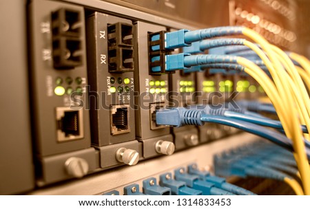 fiber optical cables connected to optic ports and UTP Network cables connected to ethernet ports.