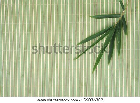 Bamboo leaves on bamboo background