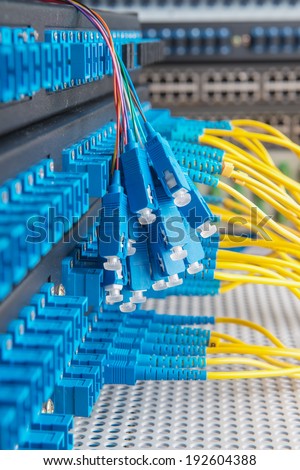 Panel of Fiber network switch with some yellow optical network cables