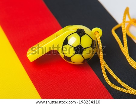 football shape whistle on Germany flag background.