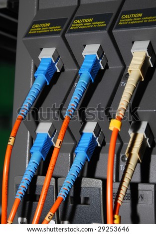 fiber cables connected to servers in a datacenter(See more network cables and servers backgrounds in my portfolio).