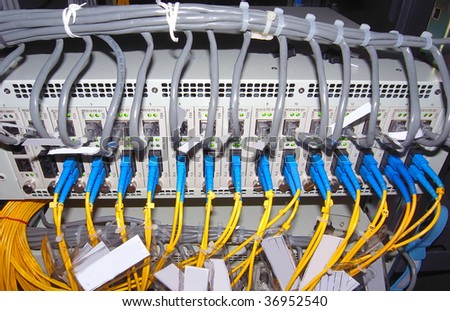 network hub and patch cables,Fiber cables connected to servers in a datacenter(See more network cables and servers backgrounds in my portfolio).