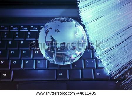 Abstract computer with technology earth globe against fiber optic background