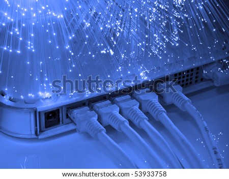 network cable and hub closeup with fiber optical background