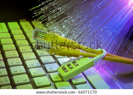 Lock and network cable with computer keyboard background