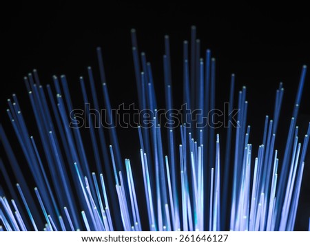 bunch of optical fibres dinamic flying from deep on technology background, blur