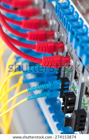 Fiber Optic cables connected to an optic ports and UTP Network cables connected to an Fast/Giga Ethernet ports