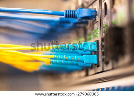 Fiber Optic cables connected to an optic ports and Network cables connected to ethernet ports.