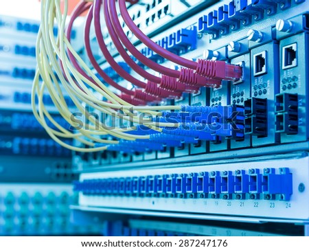 Fiber Optic cables connected to an optic ports and UTP Network cables connected to an Fast/Giga Ethernet ports