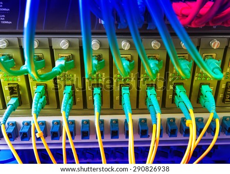 Fiber Optic cables connected to an optic ports and UTP Network cables connected to ethernet ports.