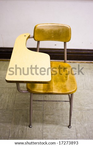Color photograph of a desk in a classroom with copy space and product space behind and on top of the desk.