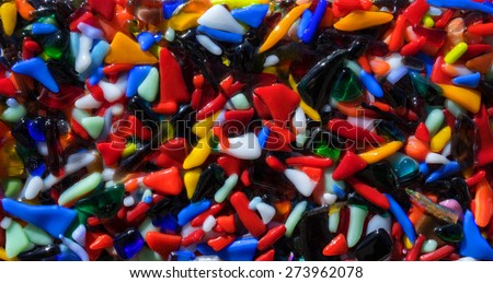 Abstract pattern of many small colorful plastic pieces, that were melted into each other