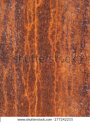 Detail of a rusty metal surface with an abstract, vertical pattern in vertical format