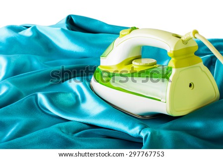 Ironing silk fabric and bright iron on a white background