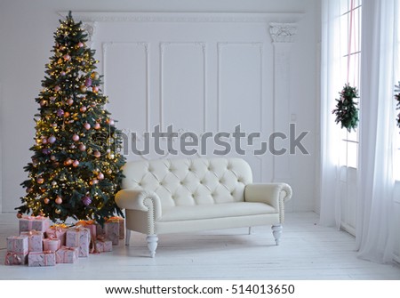 Stylish Christmas scandinavian minimalistic interior with an elegant sofa. Comfort home. Presents and wrapped gifts under the Christmas tree with light and bauble in sunny living room