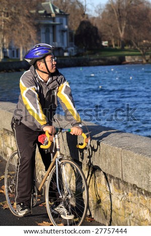 asian male cycle athlete training beside the lake