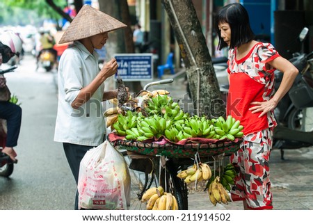 Hanoi, Vietnam Aug 20, 2014: Unidentified Fruit seller in a street in Hanoi Vietnam. This is a specific tradition in Hanoi old quarter.