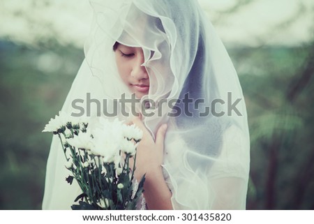 Pretty girl holding bouquet of white flowers. Portrait woman in Vintage style
