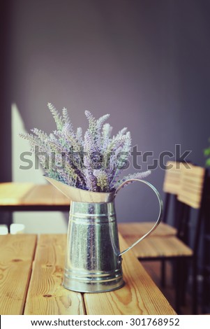 Vase of flowers on a table at cafe. Decoration coffee shop in vintage style