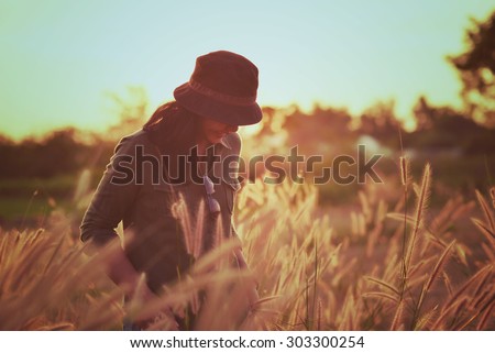 Woman in meadow. travel and sunset in vintage style