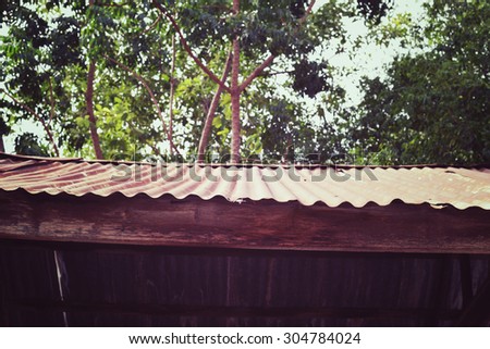 Old galvanized sheet Roof on forest background. Country Village in vintage style